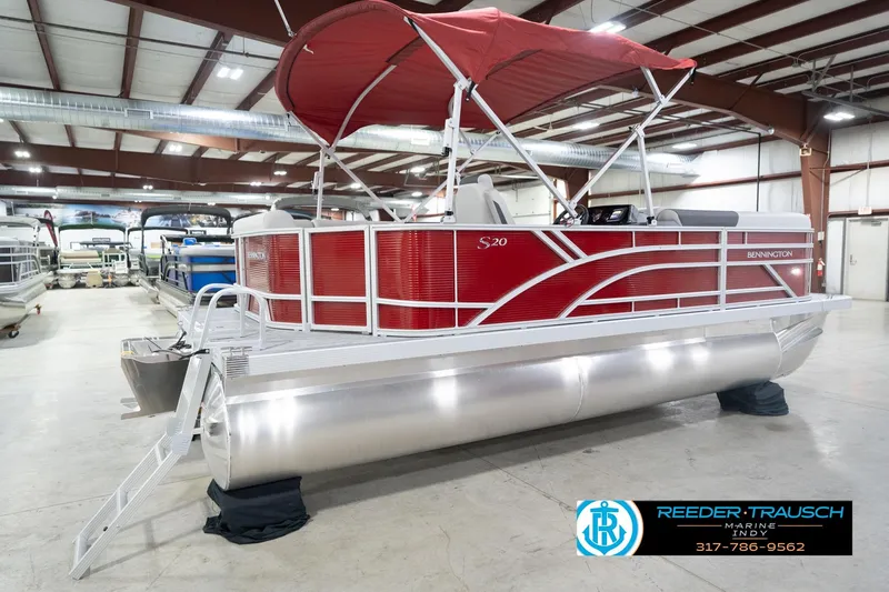 Slide: The Image of 2026 Bennington 20 SL pontoon boat with red canopy in showroom. - 8