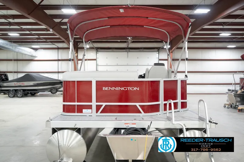 Slide: The Image of 2026 Bennington 20 SL pontoon boat with red canopy in a showroom. - 9