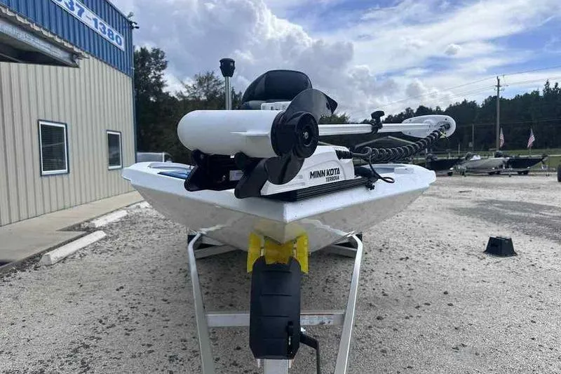 Slide: The Image of 2026 Xpress H22 boat with Minn Kota trolling motor on trailer, outdoor setting. - 11