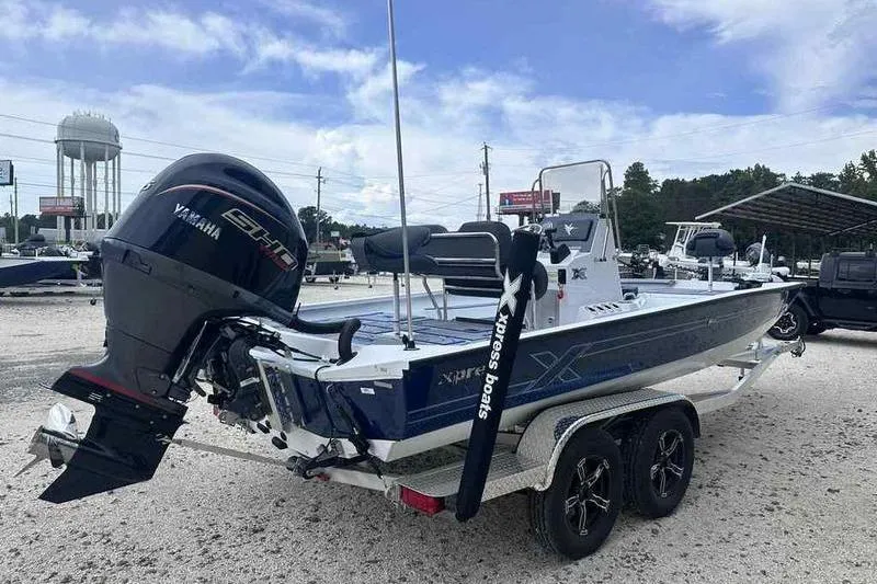 Slide: The Image of 2026 Xpress H22 boat with Yamaha engine on trailer, parked outdoors. - 13