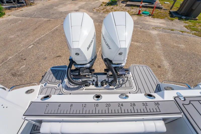Slide: The Image of 2021 Blackfin 272 CC boat with dual Mercury outboard engines, featuring a measuring ruler on deck. - 10