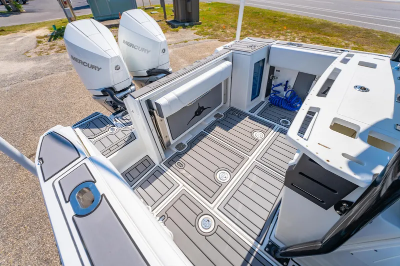 Slide: The Image of 2021 Blackfin 272 CC boat deck with dual Mercury engines, featuring spacious layout and modern design. - 11