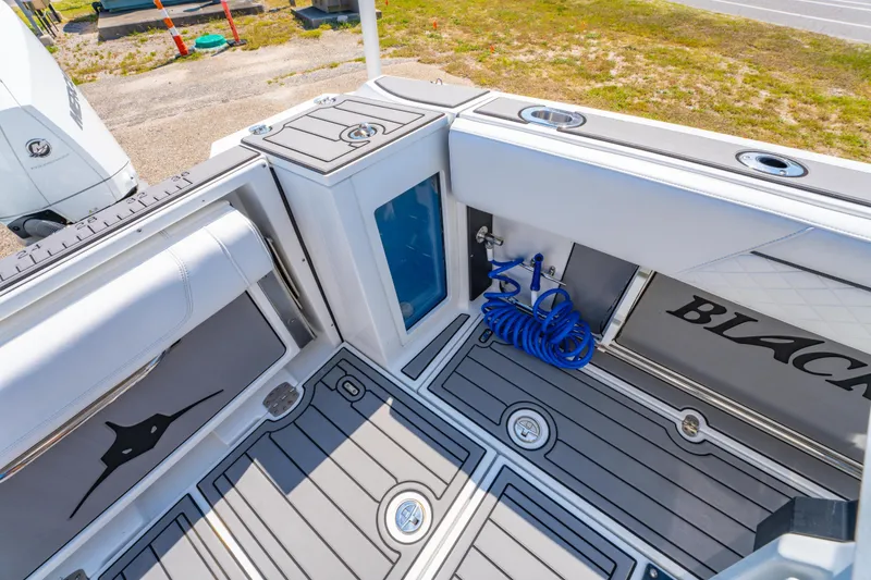 Slide: The Image of 2021 Blackfin 272 CC boat deck with storage, hose, and seating area. - 13