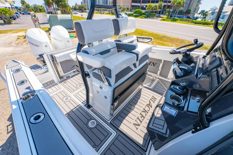 Slide: The Image of 2021 Blackfin 272 CC boat interior with dual Mercury engines and modern helm controls. - 16