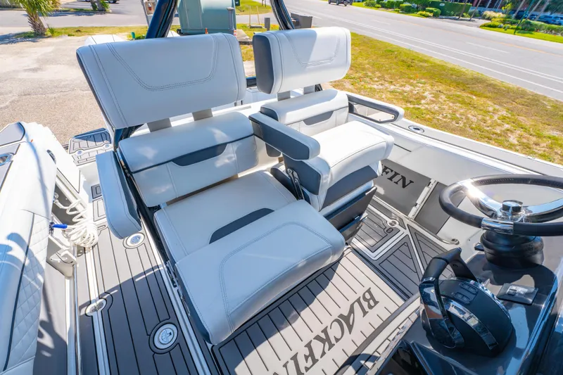 Slide: The Image of 2021 Blackfin 272 CC boat interior with white seating and steering wheel. - 17