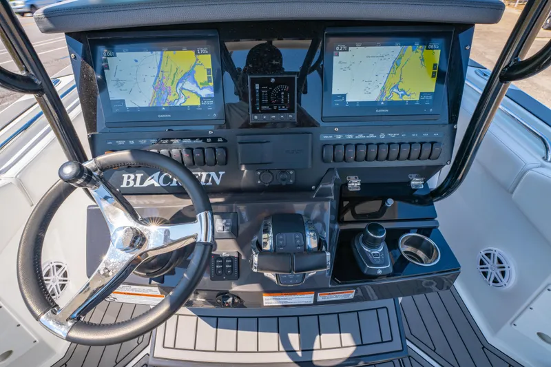 Slide: The Image of 2021 Blackfin 272 CC boat dashboard with dual Garmin displays and steering wheel. - 18