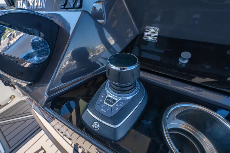 Slide: The Image of Control panel of 2021 Blackfin 272 CC boat with joystick and cup holder. - 19