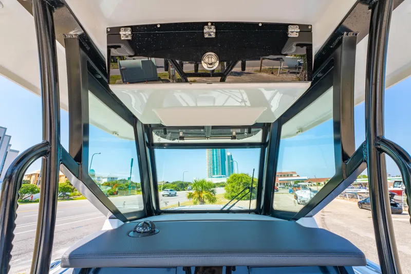 Slide: The Image of 2021 Blackfin 272 CC boat interior with windshield and urban background. - 20