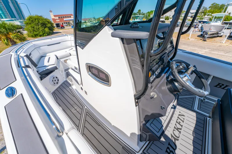 Slide: The Image of 2021 Blackfin 272 CC boat interior with sleek helm and seating area. - 22