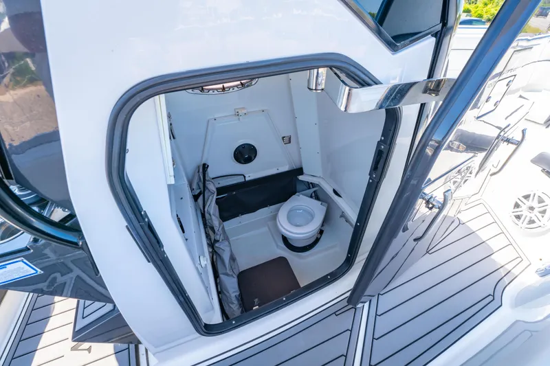 Slide: The Image of 2021 Blackfin 272 CC boat interior with compact marine toilet. - 27