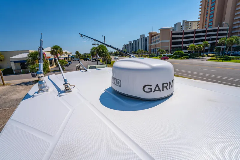 Slide: The Image of 2021 Blackfin 272 CC boat with Garmin radar, parked near buildings and palm trees. - 28