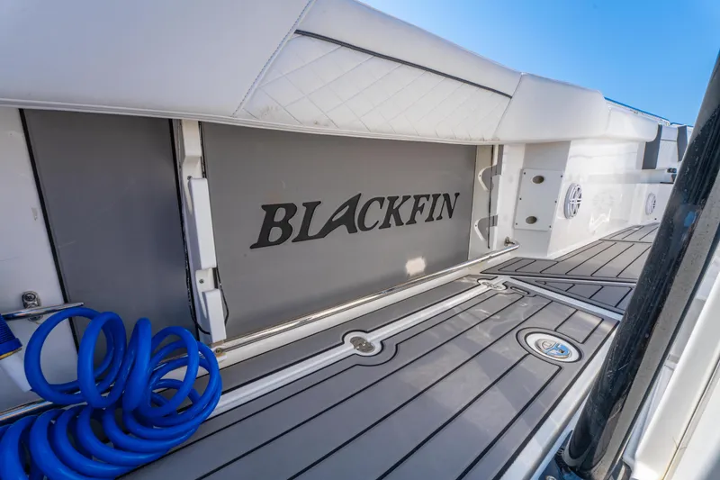 Slide: The Image of 2021 Blackfin 272 CC boat deck with logo and coiled blue hose. - 29