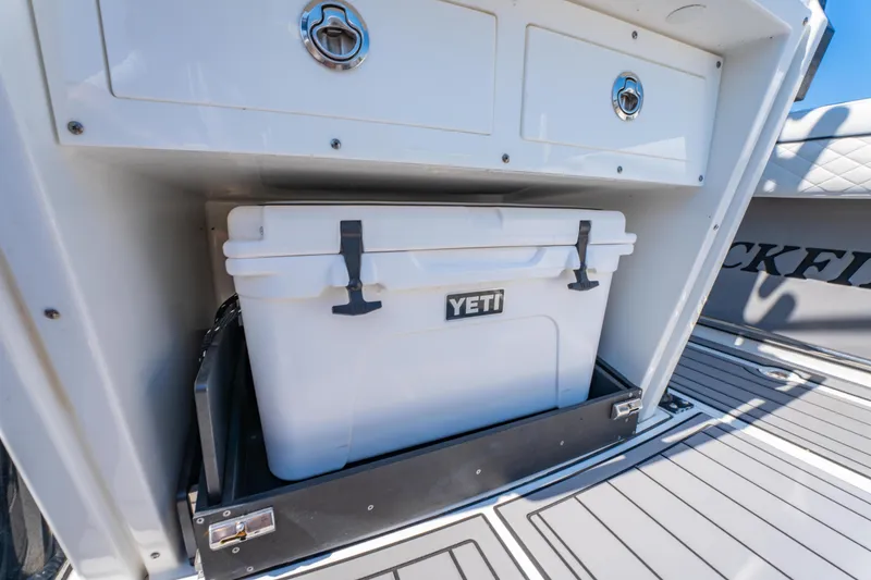 Slide: The Image of 2021 Blackfin 272 CC boat with Yeti cooler in storage compartment. - 30