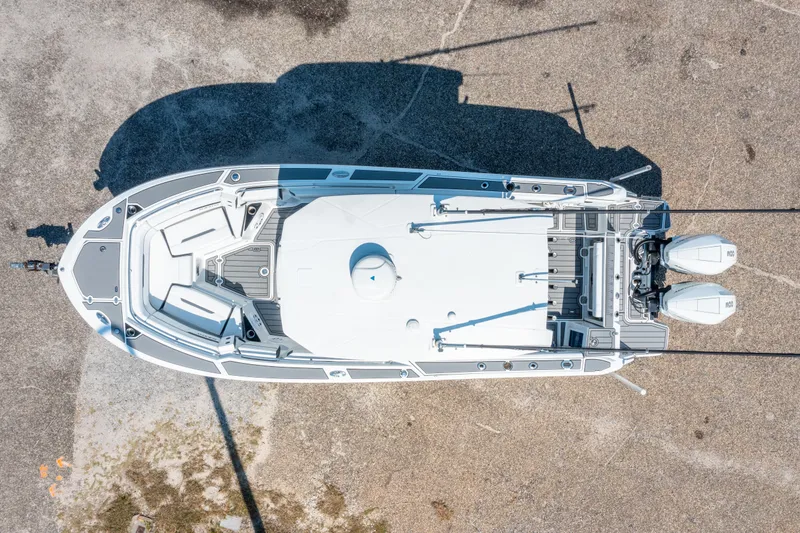 Slide: The Image of Aerial view of 2021 Blackfin 272 CC boat on dry land, showcasing deck layout and twin engines. - 33