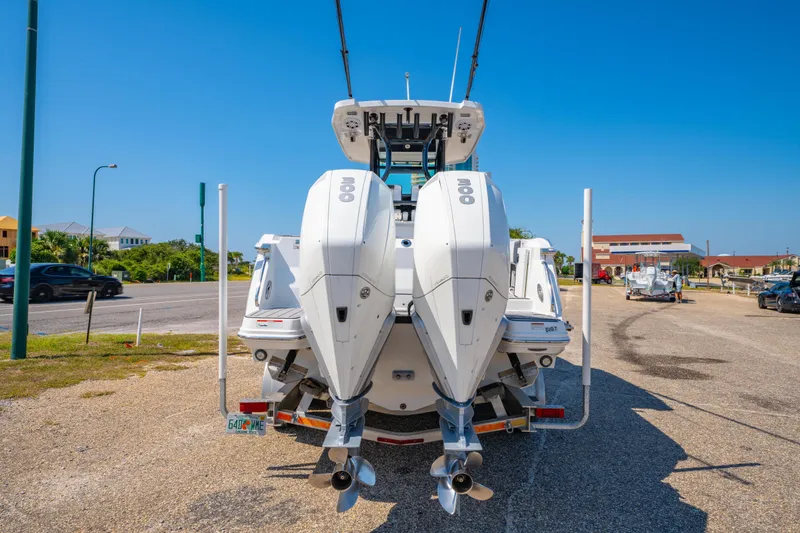 Slide: The Image of 2021 Blackfin 272 CC boat with dual outboard engines parked on a sunny day. - 4