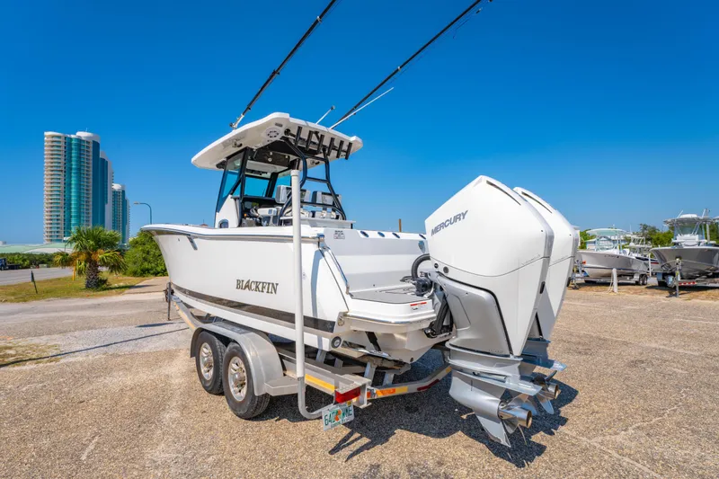 Slide: The Image of 2021 Blackfin 272 CC boat with dual Mercury engines on a trailer, sunny day. - 5