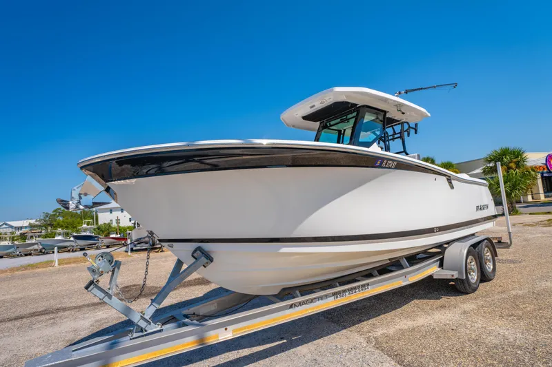 Slide: The Image of 2021 Blackfin 272 CC boat on trailer under clear blue sky. - 7
