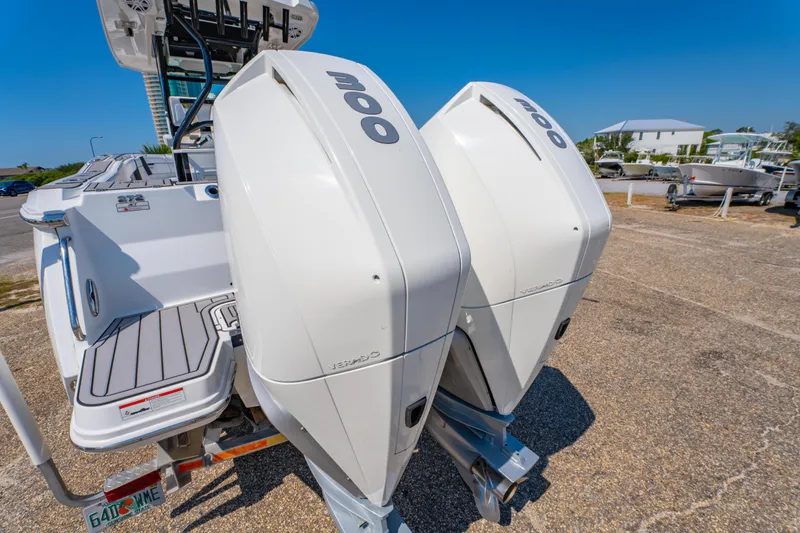 Slide: The Image of 2021 Blackfin 272 CC boat with dual 300 horsepower outboard engines, parked on a sunny day. - 8