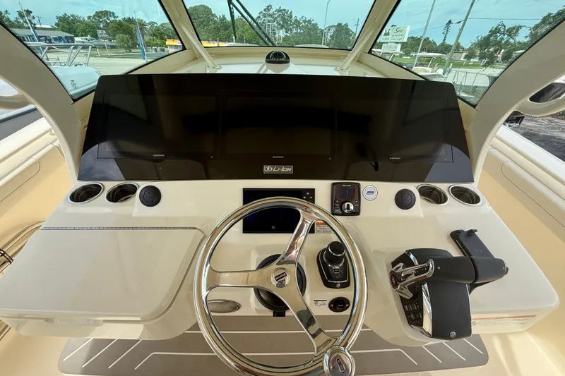 Slide: The Image of 2026 Scout 400 LXF Li-Ion boat interior with stainless steel appliance and seating area. - 14
