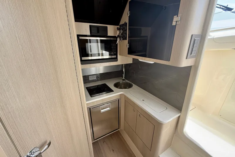 Slide: The Image of Open storage compartment of 2026 Scout 400 LXF Li-Ion boat, showcasing interior space. - 29