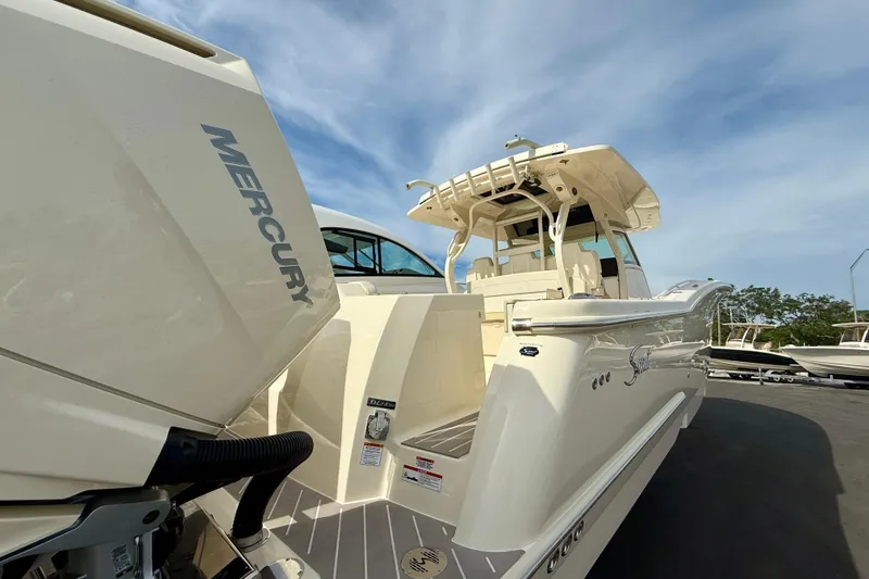 Slide: The Image of 2026 Scout 400 LXF Li-Ion boat on calm water with city skyline backdrop. - 3