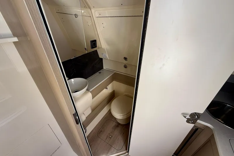 Slide: The Image of Compact bathroom interior of 2026 Scout 400 LXF Li-Ion boat, featuring modern fixtures. - 35