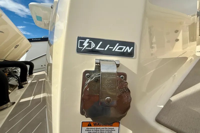 Slide: The Image of 2026 Scout 400 LXF Li-Ion boat with charging port and warning label. - 37