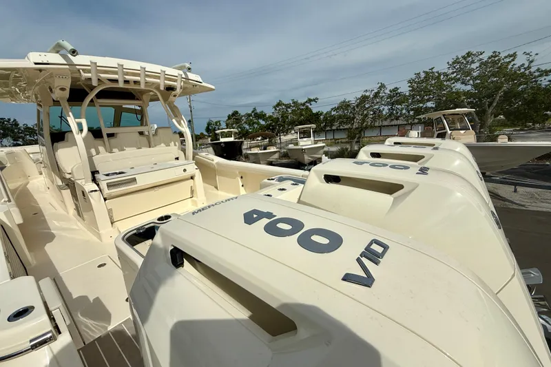 Slide: The Image of 2026 Scout 400 LXF Li-Ion boat cruising on open water, showcasing sleek design and luxury features. - 4