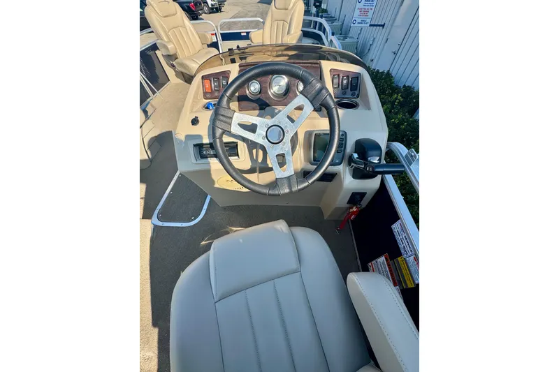 Slide: The Image of 2015 Bennington 24 SFX boat interior with steering wheel and control panel. - 10
