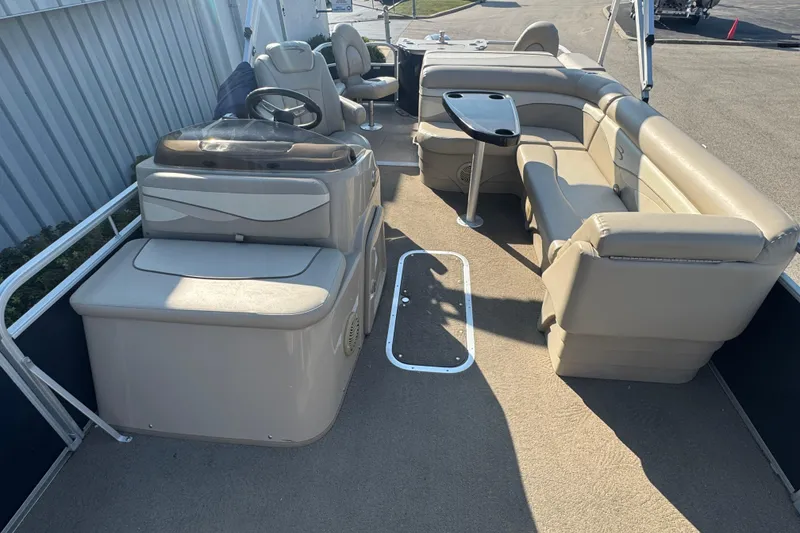 Slide: The Image of 2015 Bennington 24 SFX pontoon boat interior with beige seating and steering console. - 13