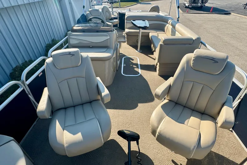 Slide: The Image of 2015 Bennington 24 SFX pontoon boat interior with beige seating and steering console. - 18
