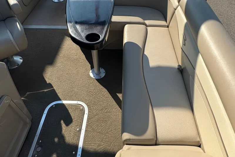 Slide: The Image of Interior of a 2015 Bennington 24 SFX boat with beige seating and table. - 21