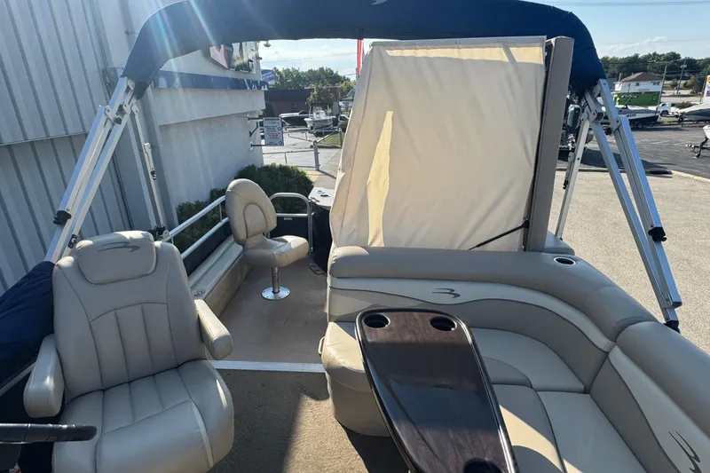 Slide: The Image of 2015 Bennington 24 SFX pontoon boat interior with seating and canopy. - 26