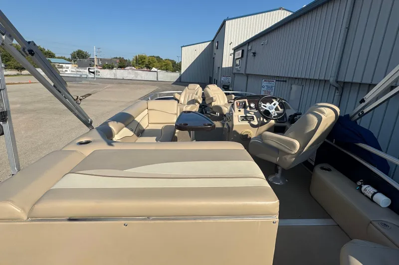 Slide: The Image of 2015 Bennington 24 SFX pontoon boat with beige seating and steering console. - 29