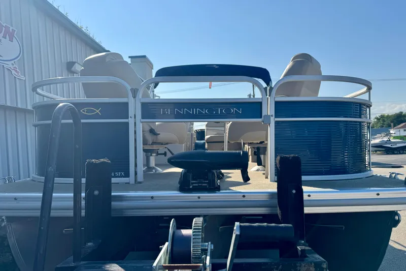 Slide: The Image of 2015 Bennington 24 SFX pontoon boat, rear view, parked outdoors. - 4