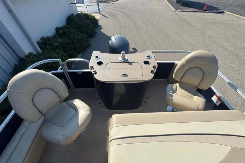 Slide: The Image of 2015 Bennington 24 SFX boat interior with beige seating and control panel. - 8