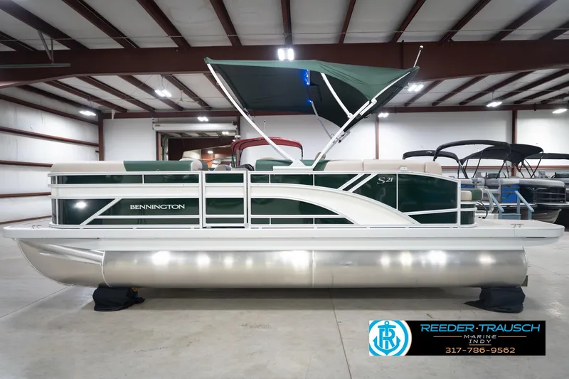 Slide: The Image of 2026 Bennington 20 SLJ pontoon boat in showroom with green canopy. - 11