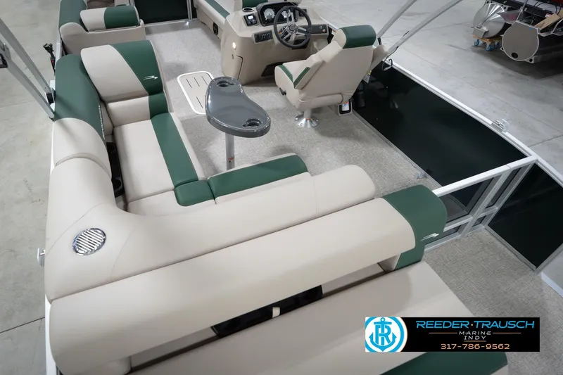 Slide: The Image of 2026 Bennington 20 SLJ pontoon boat interior with green and beige seating, steering console. - 15