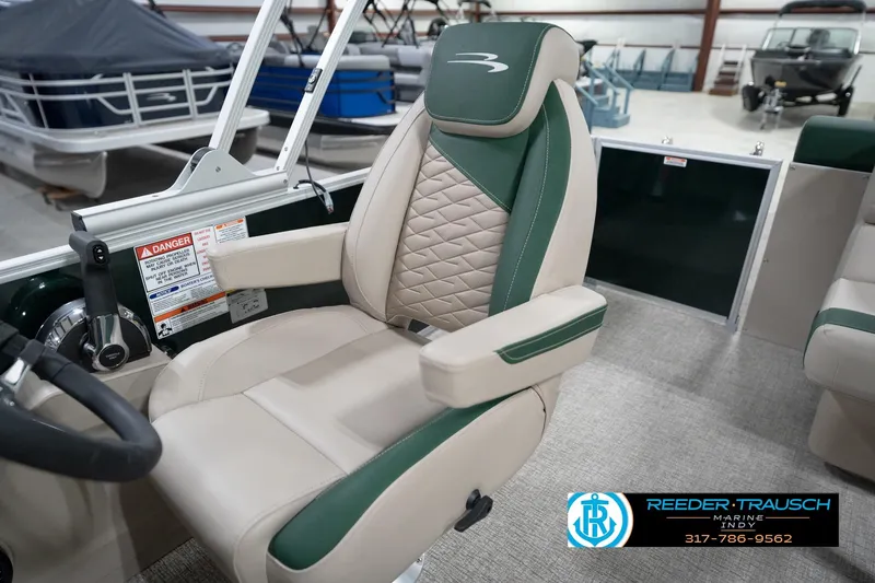 Slide: The Image of 2026 Bennington 20 SLJ boat seat with green and beige upholstery in showroom. - 26
