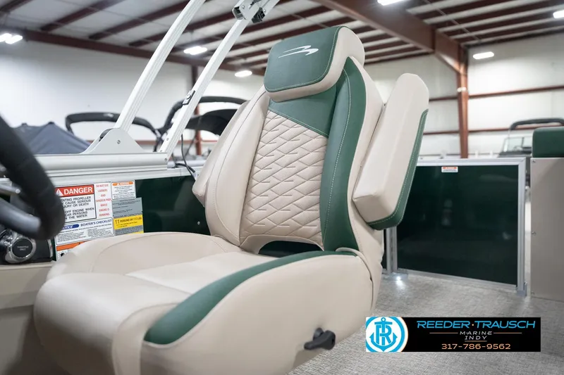 Slide: The Image of 2026 Bennington 20 SLJ boat seat with green and beige upholstery in a showroom. - 41
