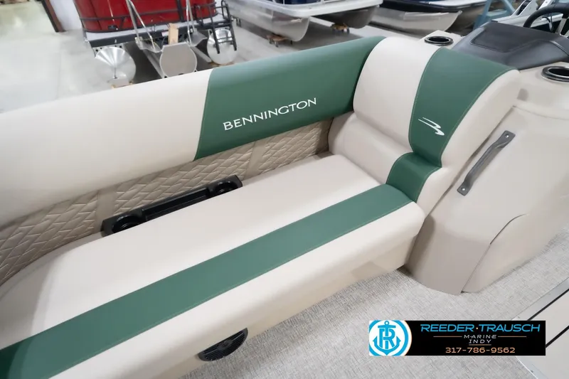 Slide: The Image of 2026 Bennington 20 SLJ boat interior with green and beige seating, Reeder-Trausch Marine logo. - 44
