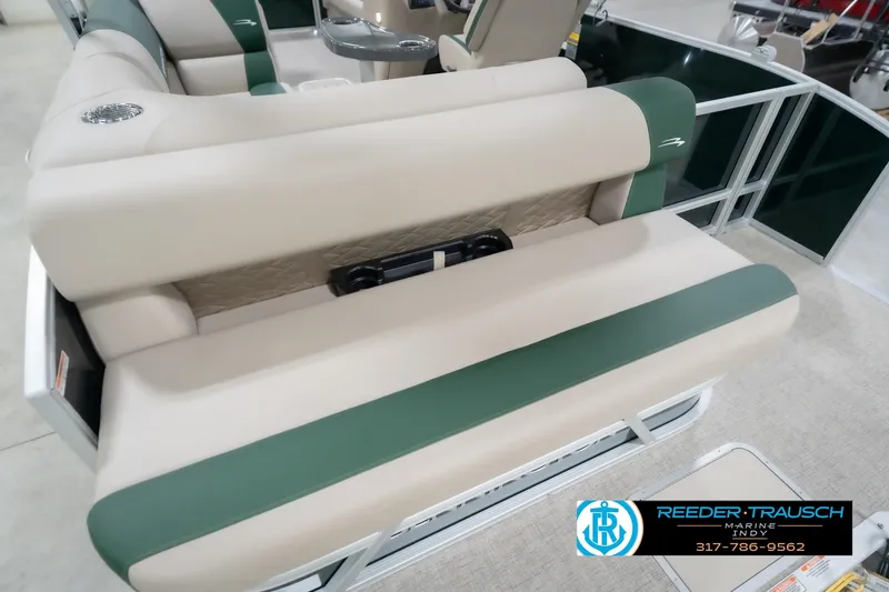 Slide: The Image of 2026 Bennington 20 SLJ boat interior with beige and green seating, Reeder-Trausch Marine logo visible. - 45