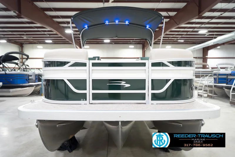 Slide: The Image of 2026 Bennington 20 SLJ pontoon boat in showroom with canopy and blue lights. - 5