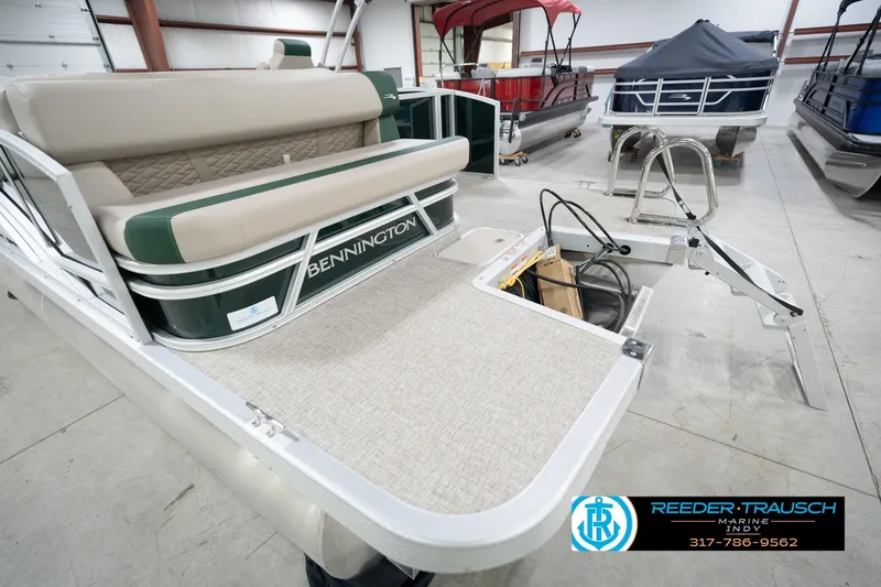 Slide: The Image of 2026 Bennington 20 SLJ pontoon boat with beige seating in a showroom. - 53