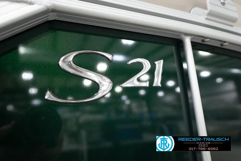 Slide: The Image of 2026 Bennington 20 SLJ boat with "S 21" emblem, Reeder-Trausch Marine logo visible. - 57