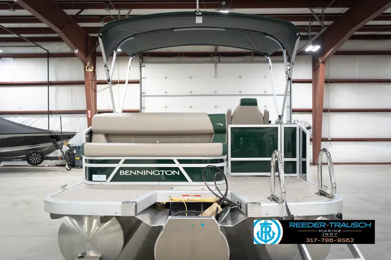 Slide: The Image of 2026 Bennington 20 SLJ pontoon boat in a showroom, featuring sleek design and comfortable seating. - 9