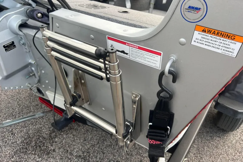 Slide: The Image of 2023 Alumacraft Voyageur 175 SC boat ladder and safety warnings. - 11
