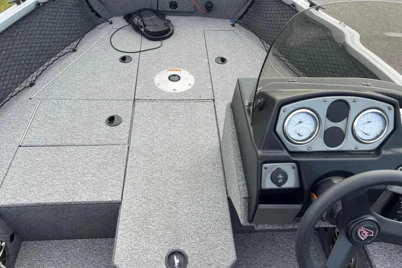 Slide: The Image of 2023 Alumacraft Voyageur 175 SC boat interior with dashboard and storage compartments. - 14