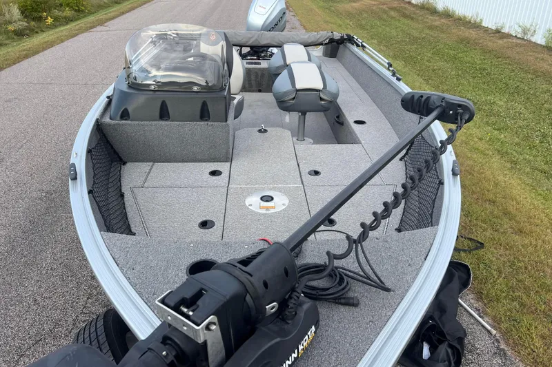 Slide: The Image of 2023 Alumacraft Voyageur 175 SC boat interior with seating and trolling motor. - 2