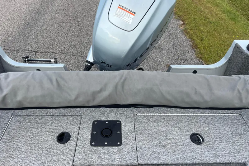 Slide: The Image of 2023 Alumacraft Voyageur 175 SC boat interior with motor and storage compartments. - 23